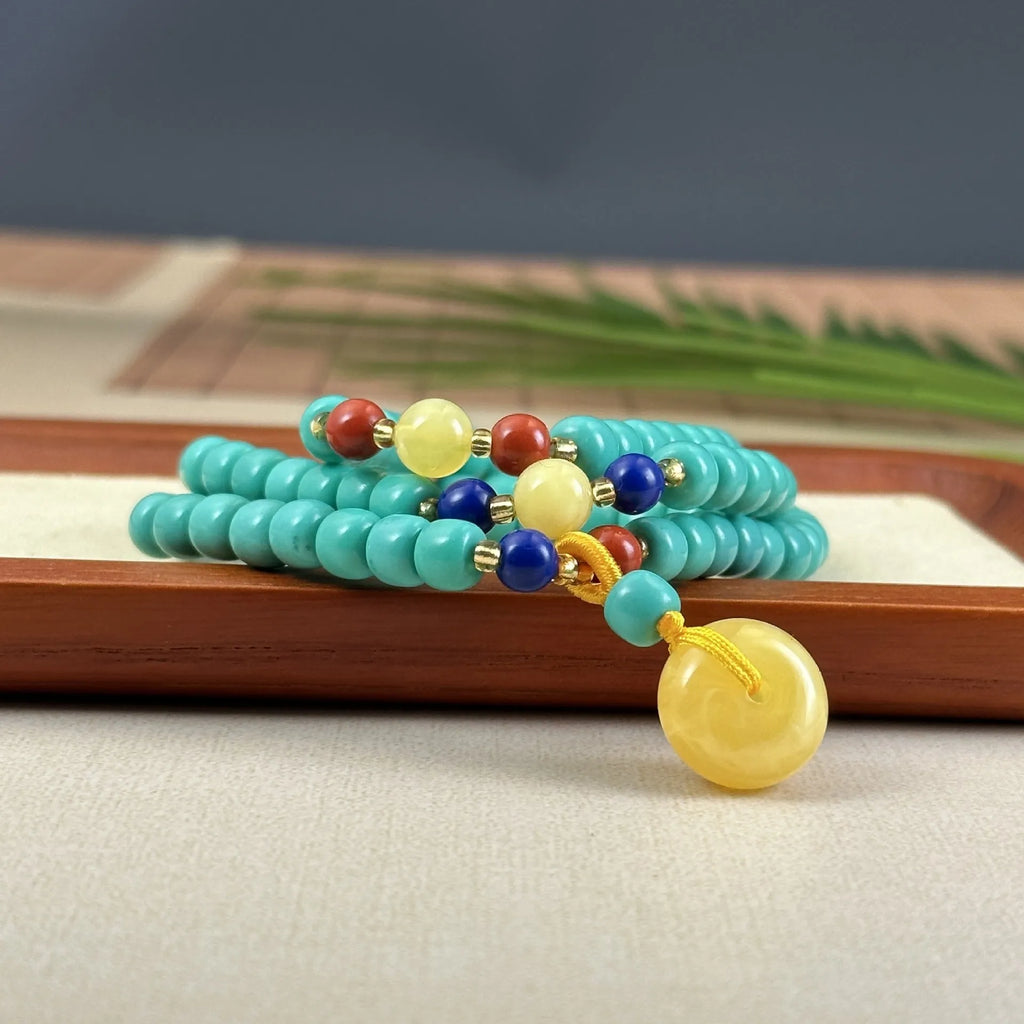Turquoise clavicle necklace with hand-woven mesh flower pendant on ball bead chain, adjustable length