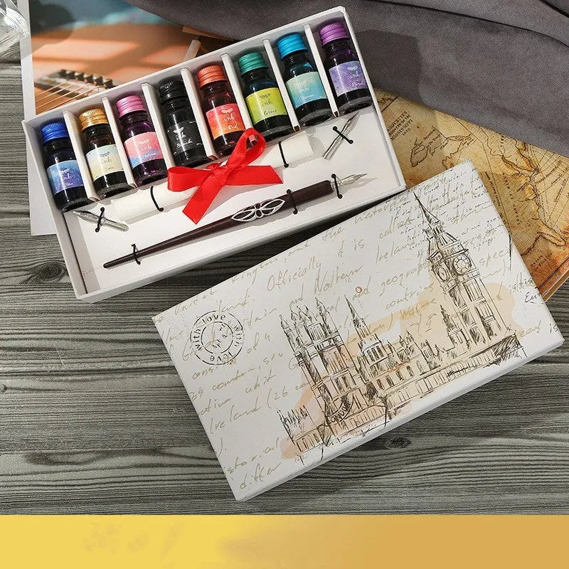 Wooden gift box open to show a dip pen, bottles of coloured ink, spare nibs, and a standing pen holder.
