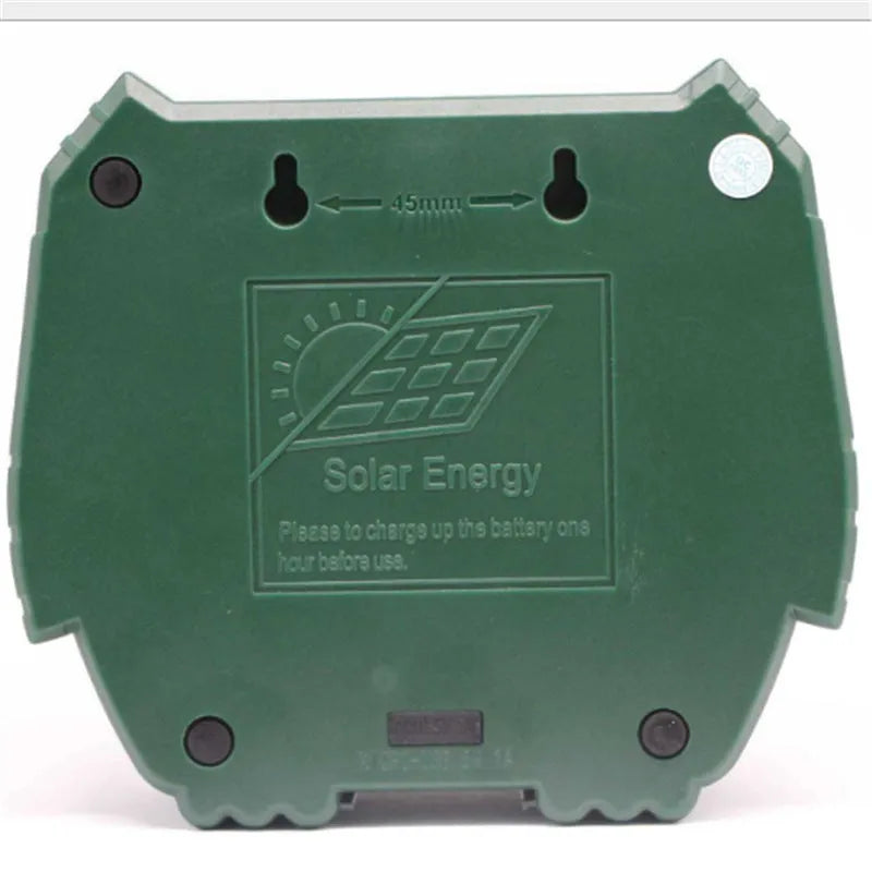 Green solar ultrasonic animal repeller with solar panel on top for outdoor pest control