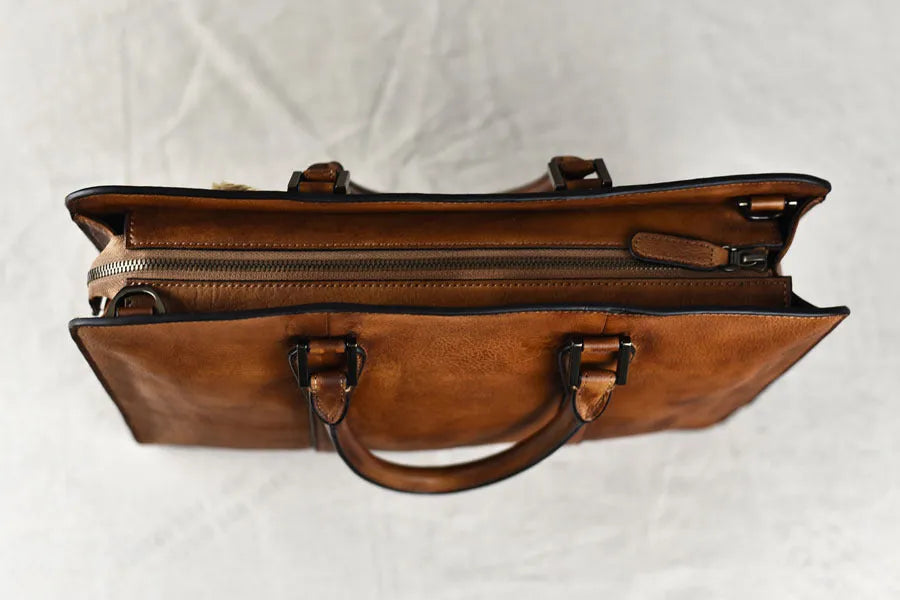 Men's brown leather retro handbag with a horizontal square shape and zipper opening