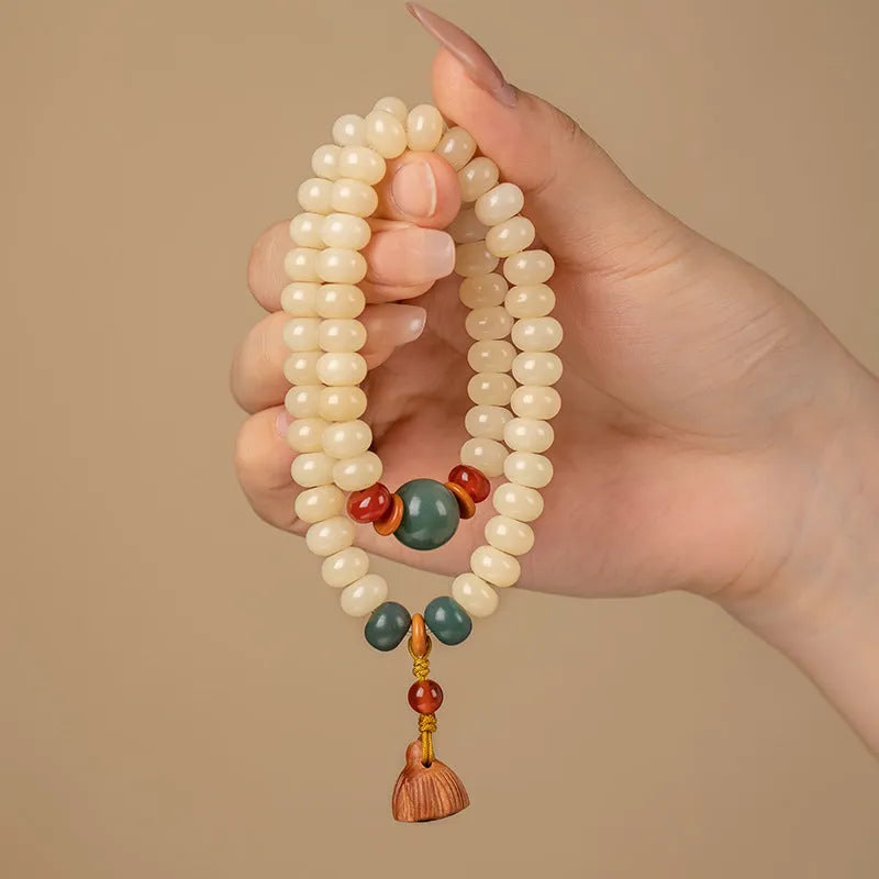 Cream Topaz Bodhi wooden bracelet with flat round beads on a wrist.