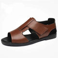 Men's black and brown open-toe leather sandals with a textured rubber sole.