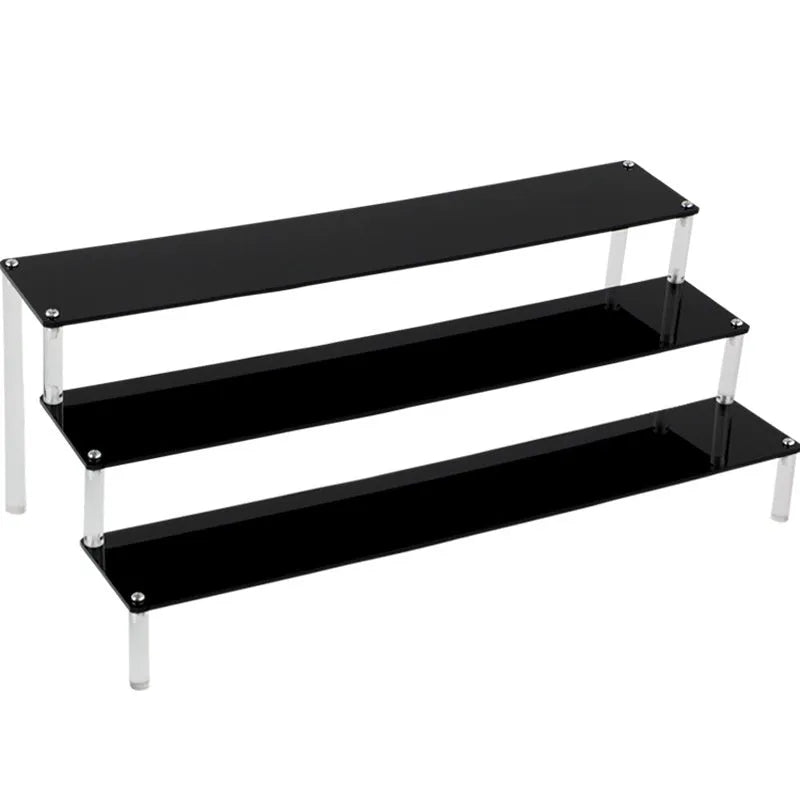 Transparent acrylic ladder display rack with three trapezoidal tiers showing blind box figurines on a desk