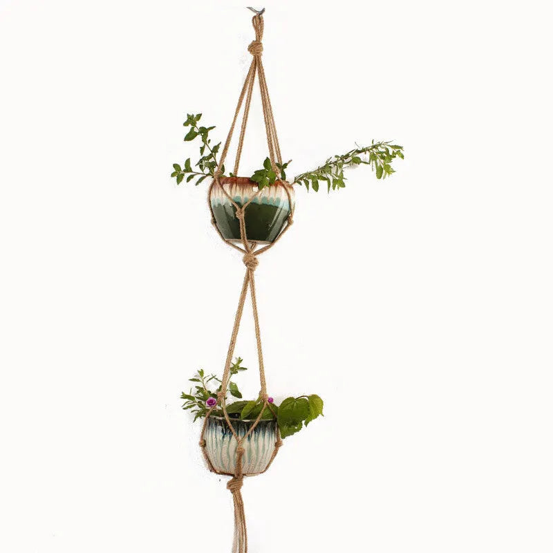 Woven wire planter basket made from cotton rope, shown in a desktop style holding a small plant.