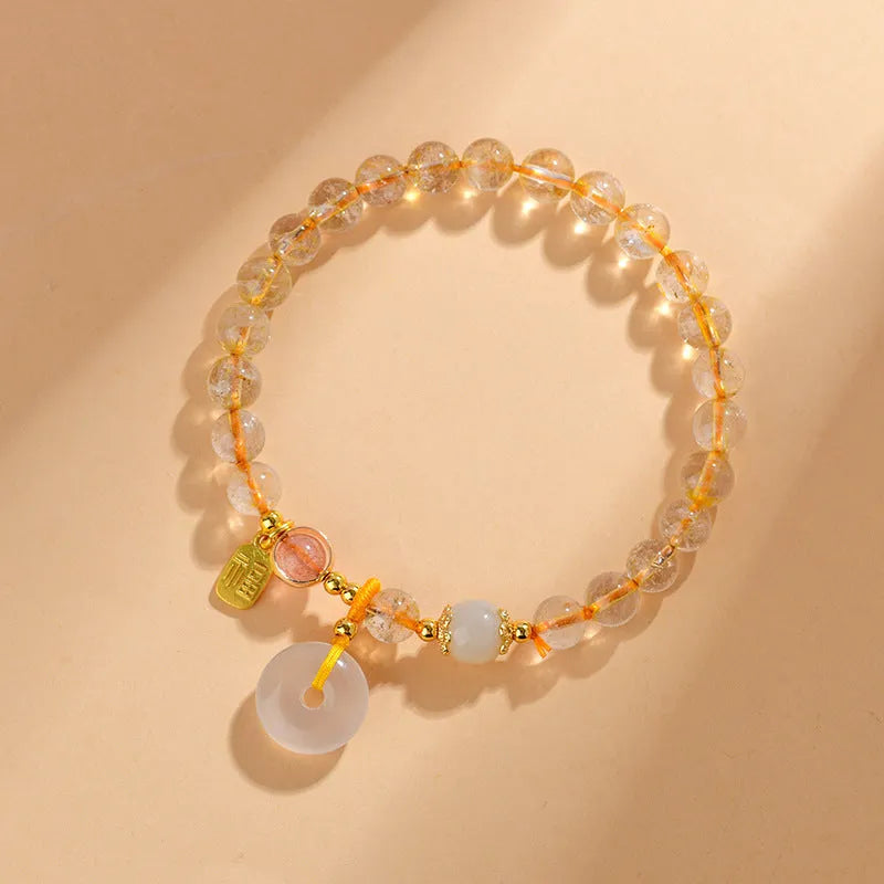 Gold rutilated quartz crystal bracelet with safety buckle closure and geometric pendant