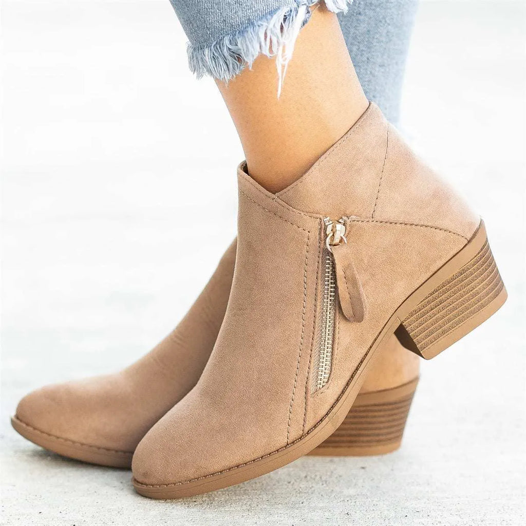 Women's blue suede ankle boots with a chunky heel and a side zip closure on a white background.