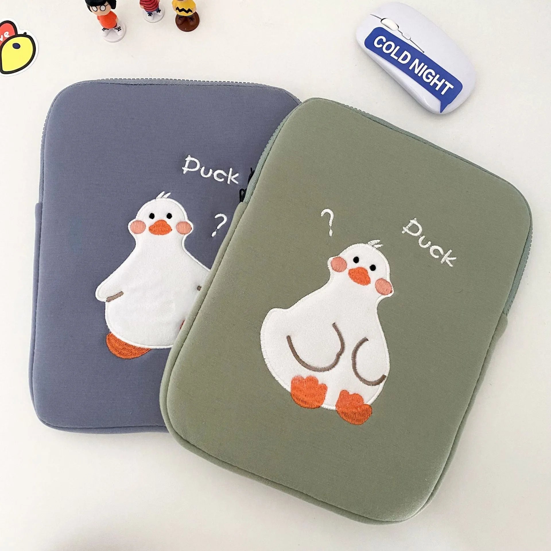 Blue cotton tablet case with embroidered cartoon duck design and zipper closure.