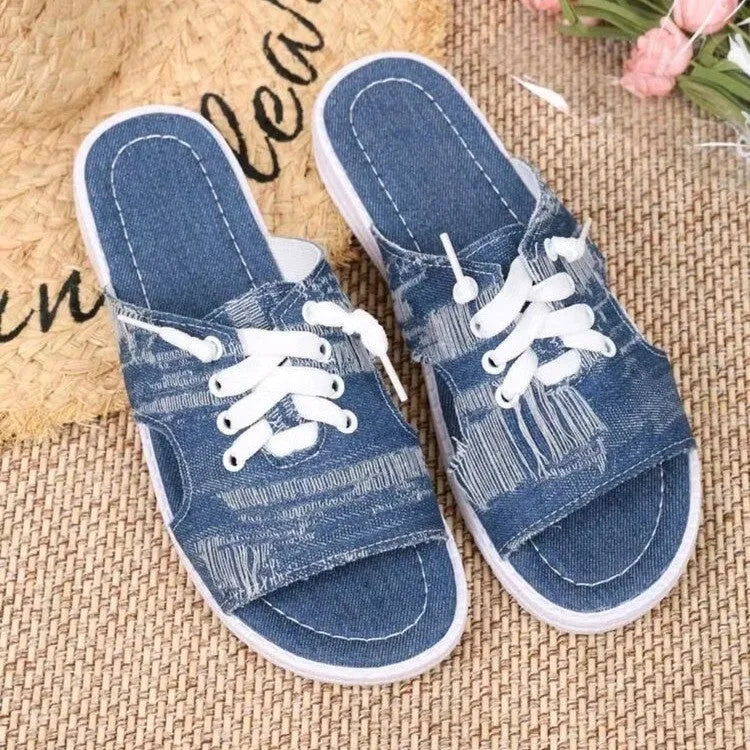 Blue Roman-style women's canvas slippers with flat design and rubber sole