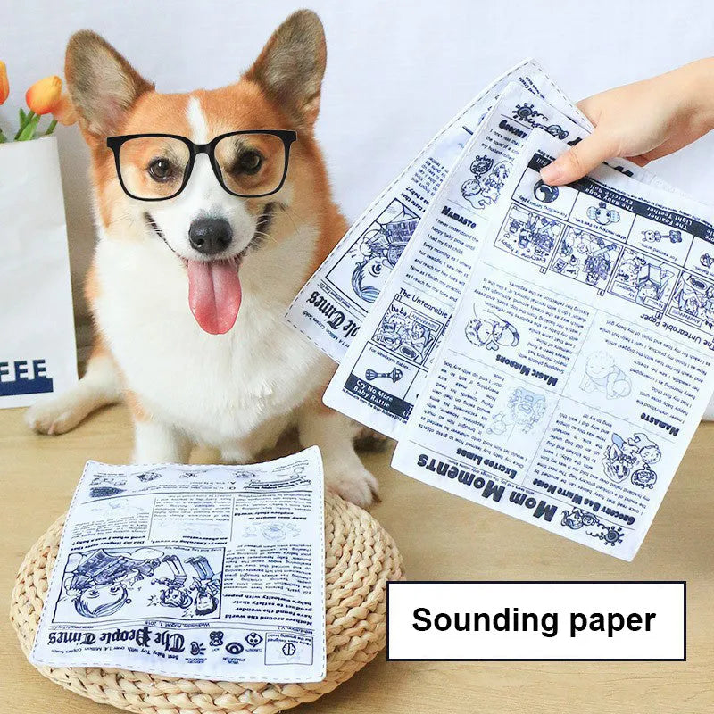 Tearproof rubber dog toy with playing card designs J, K, Q and newspaper motif with squeaking sound feature