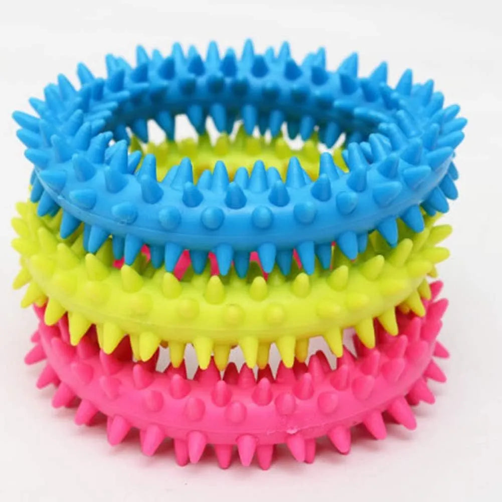 Blue TPR spiked ring dog chew toy for dental cleaning and bite training on a white background.