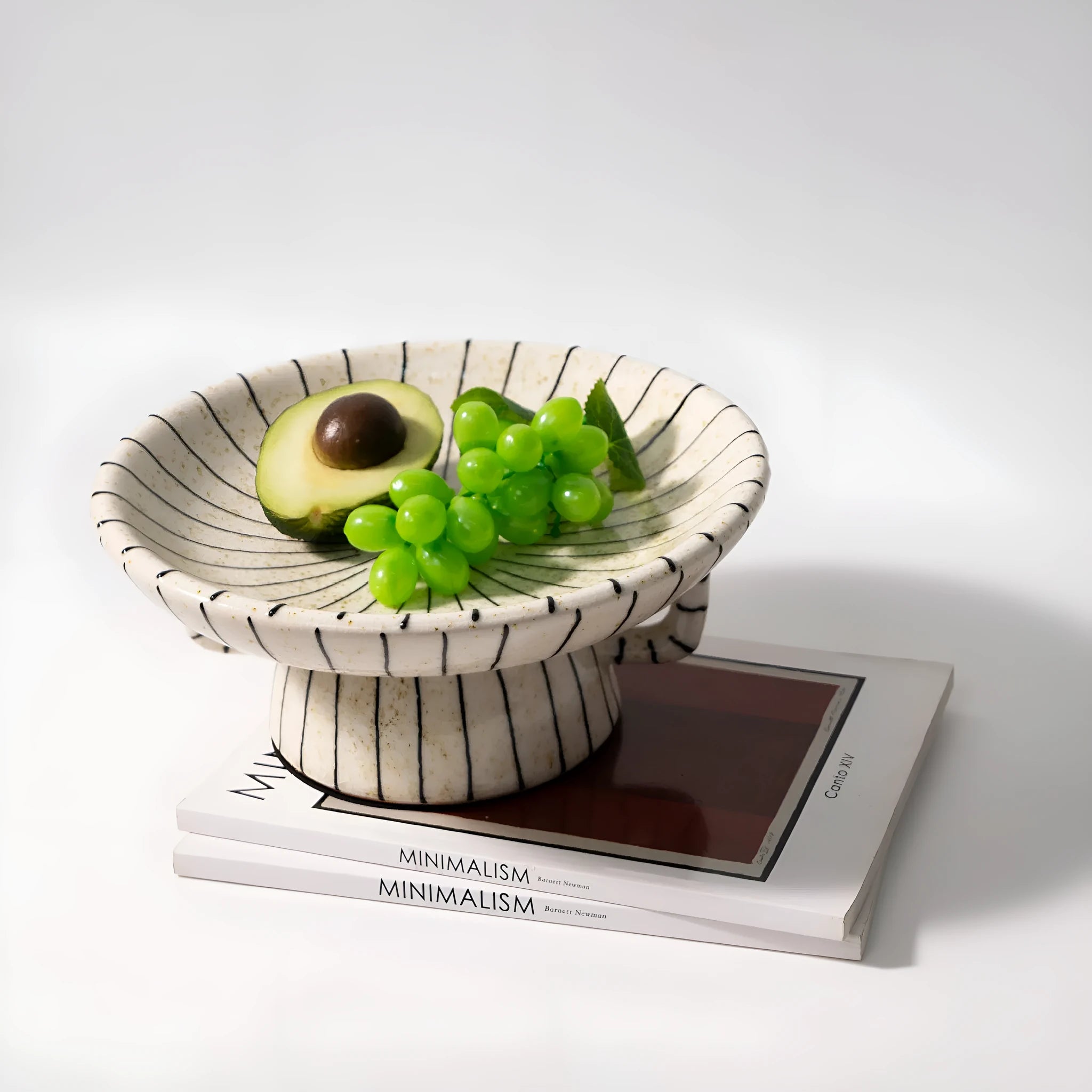 Black and white striped synthetic resin fruit plate on a wooden table.