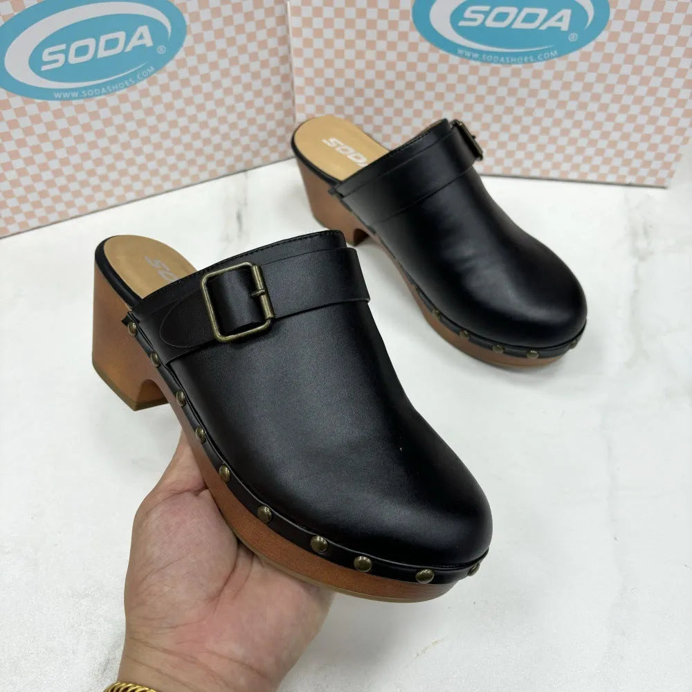 Women's black retro slippers with chunky heel, closed toe, rivet detail on ankle strap, and rubber sole.