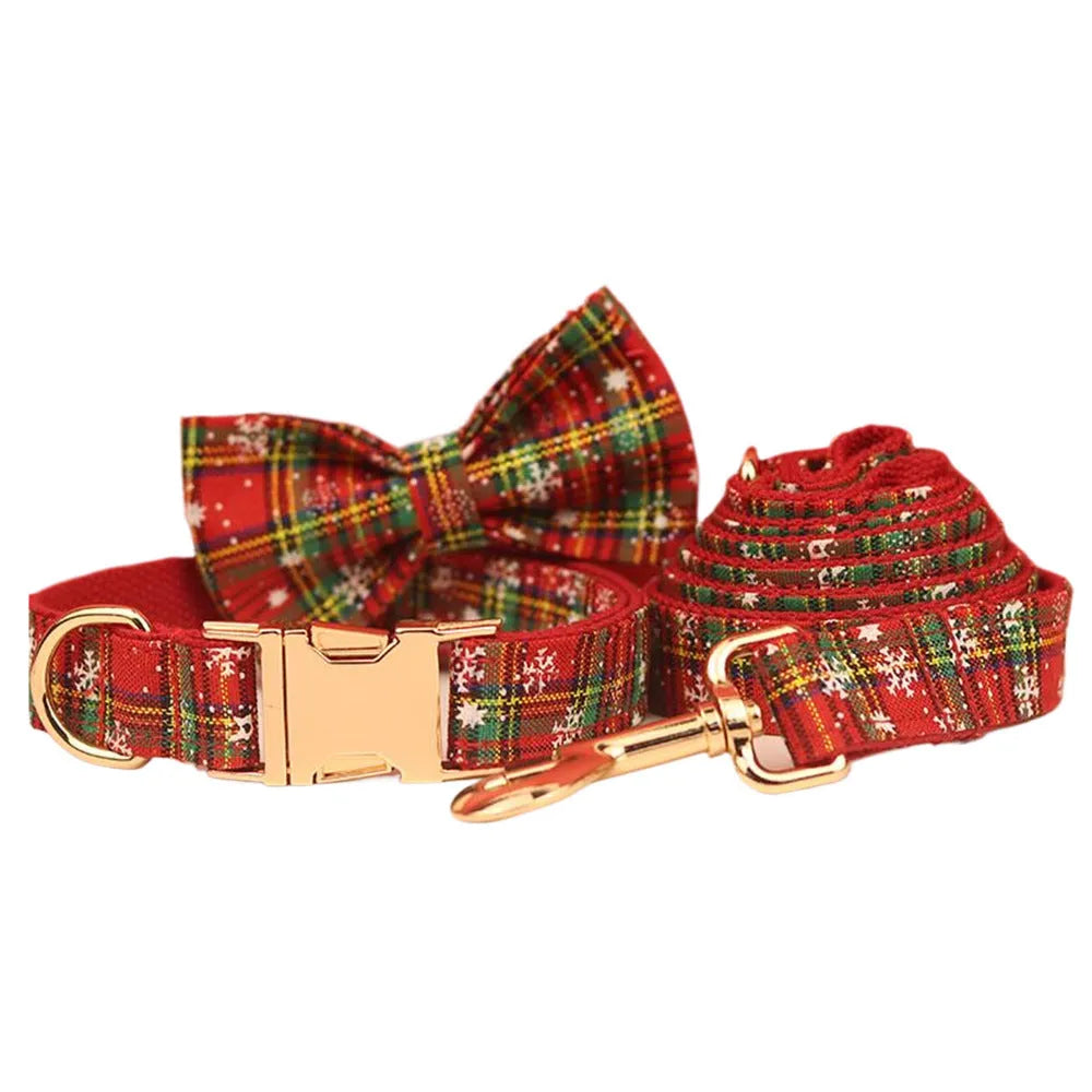 Red snowflake plaid fabric pet collar and leash set with matching dog vest and decorative bow.