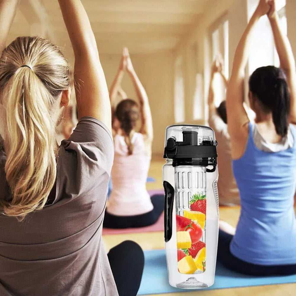 Clear 32oz Tritan plastic fruit infuser water bottle with blue lid and separate fruit infusion cup