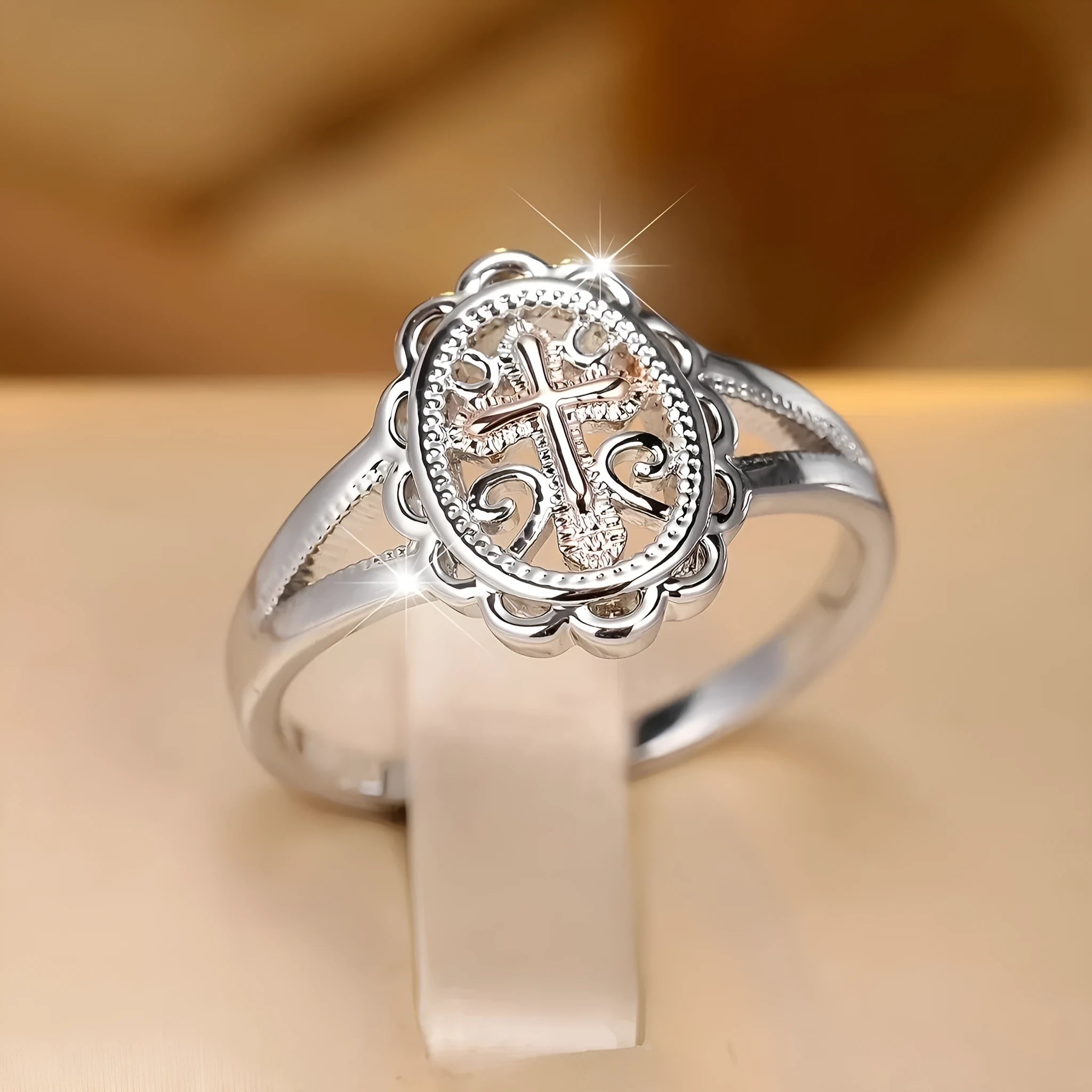 Women's silver cross lace ring showing detailed patterning and electroplated finish