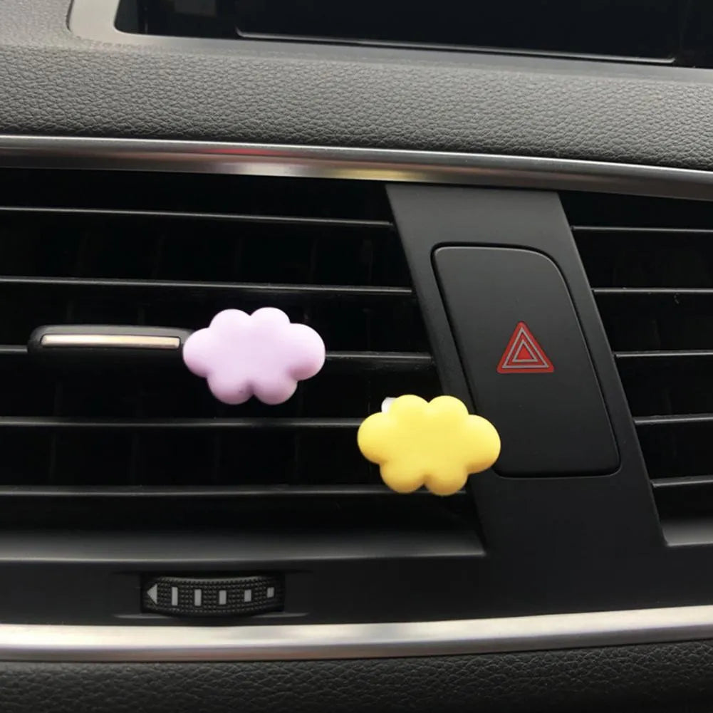 Resin cartoon cloud car fragrance clip in pastel colours mounted on vehicle air vent