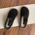 Milky white slip-on shoes with a hollow patterned linen upper and mesh lining, shown on a foot.