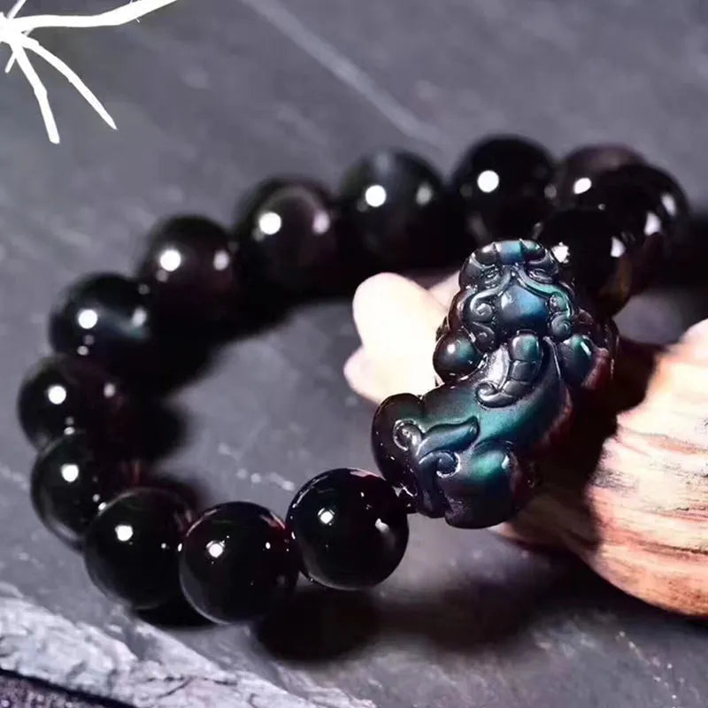 Natural ice colour eye obsidian crystal bracelet on wrist showing bead detail.