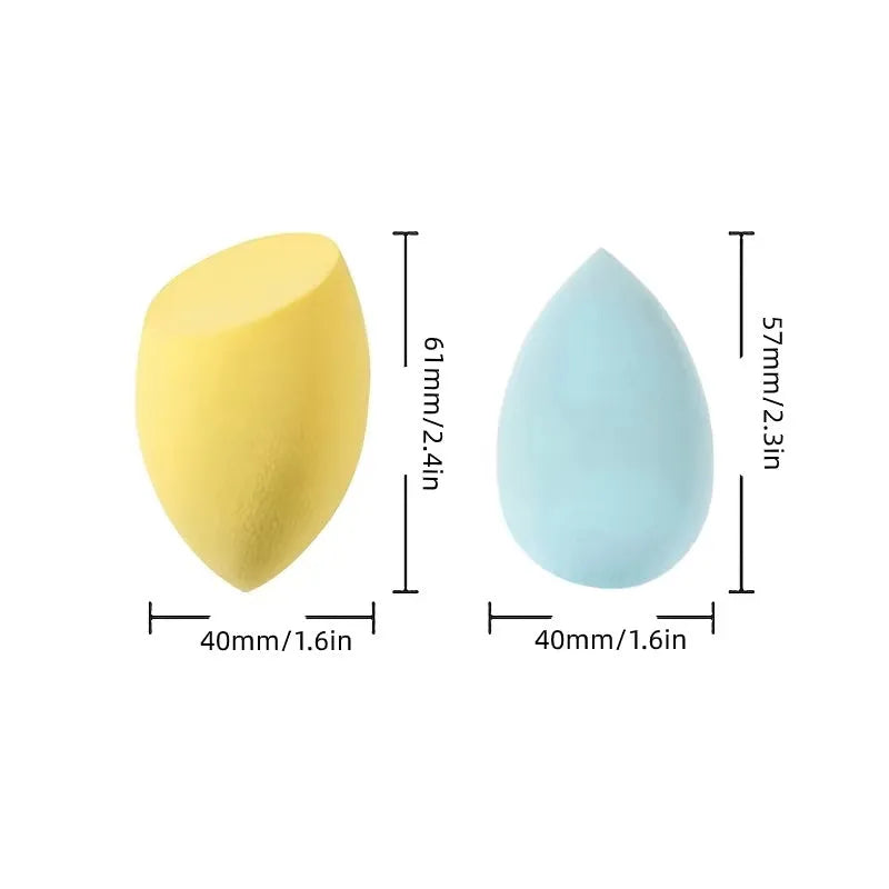 Set of seven differently shaped coloured makeup sponges including pear, heart, and drop shapes on a white background.