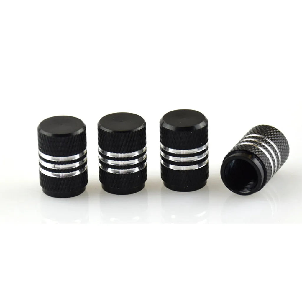 Set of coloured aluminium alloy car tyre valve caps showing stainless steel threads, displayed on a grey background.