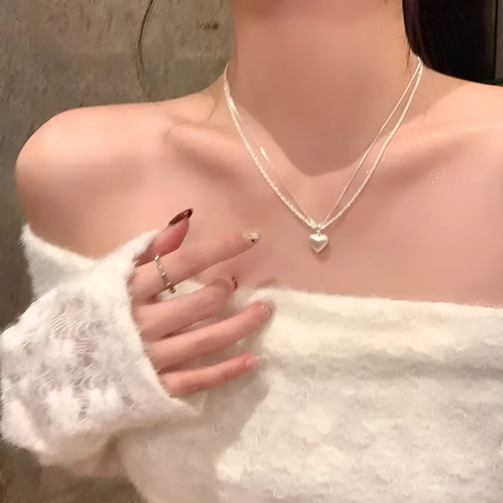 Women's double-layer brushed heart pendant necklace on a regular chain, silver tone.
