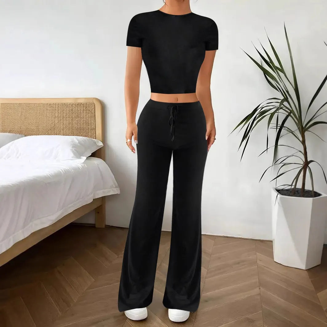 Black women's polyester tracksuit set with short sleeve top and high-waist trousers.