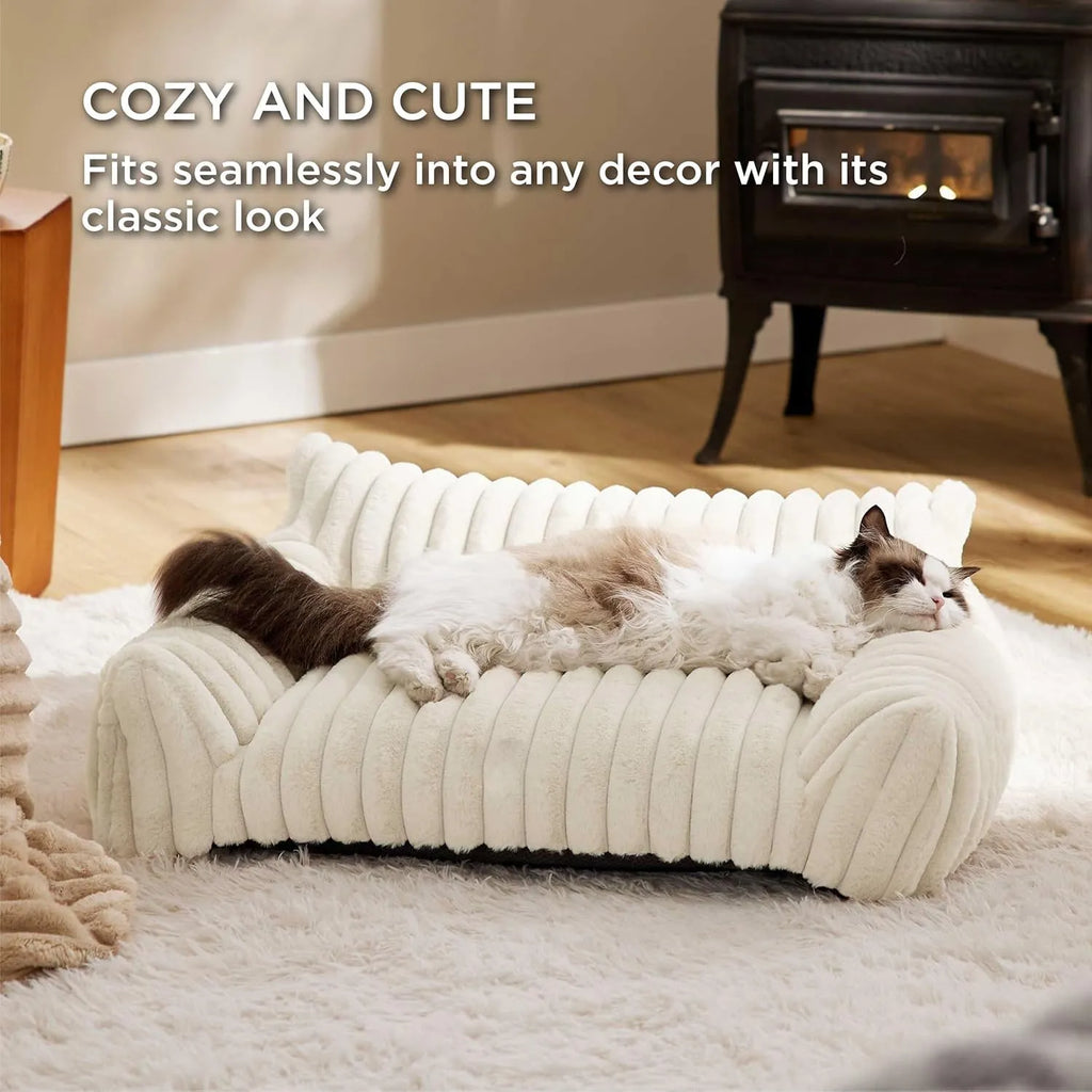 Beige corduroy fleece pet couch with high backrest and sides on a wooden floor.