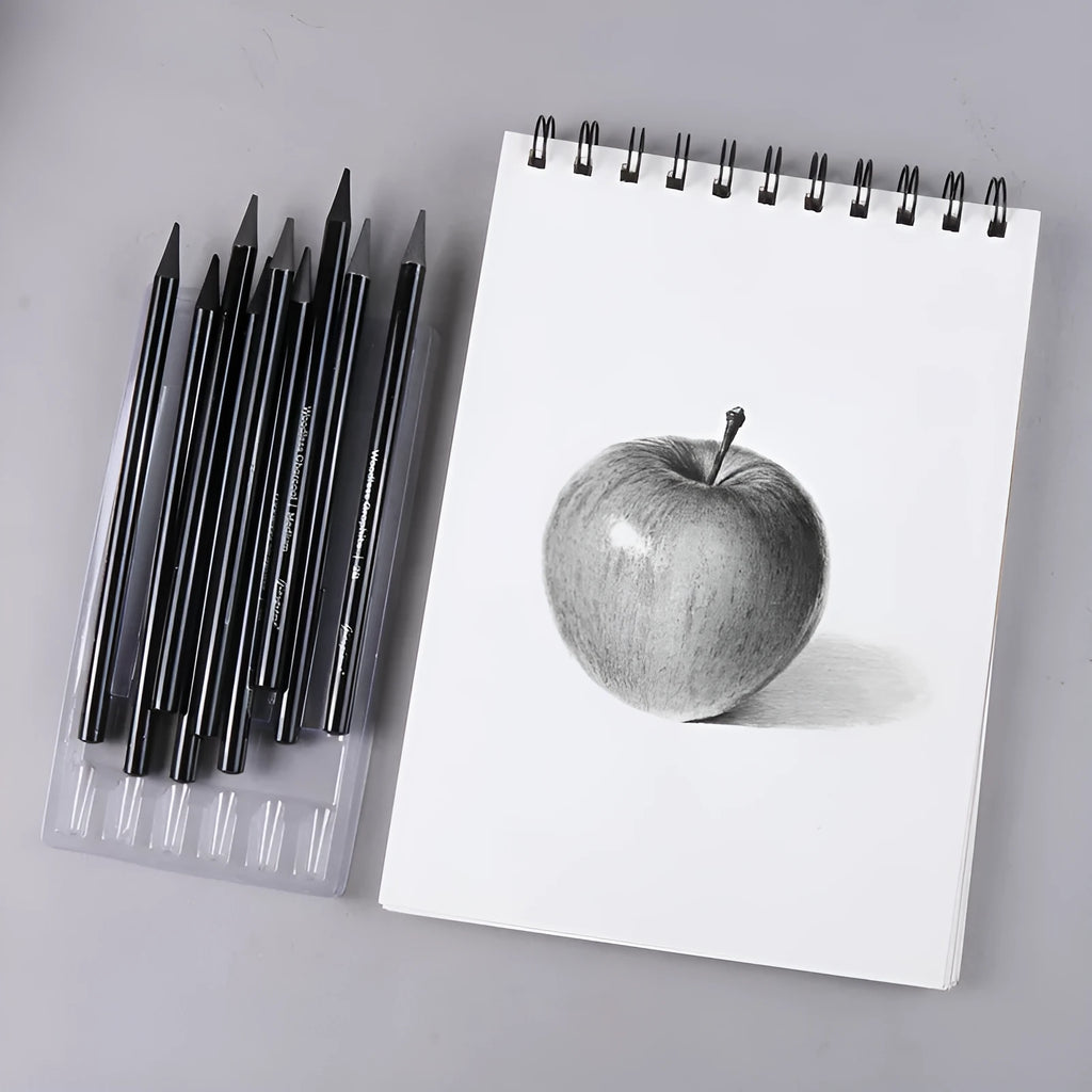 Set of six graphite pencils and three carbonized pencils with wooden shells on suction card packaging