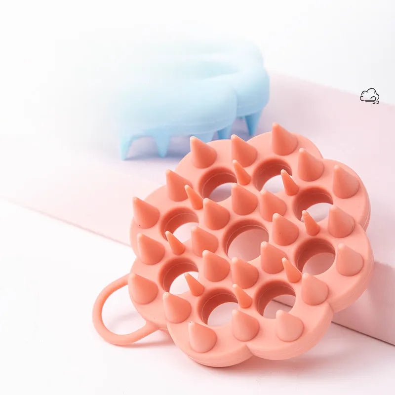 Silicone pet grooming brush with ergonomic handle shown in blue, for washing and brushing dogs and cats.