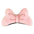 A soft red plush bow tie decoration for attaching to a motorcycle or ski helmet.
