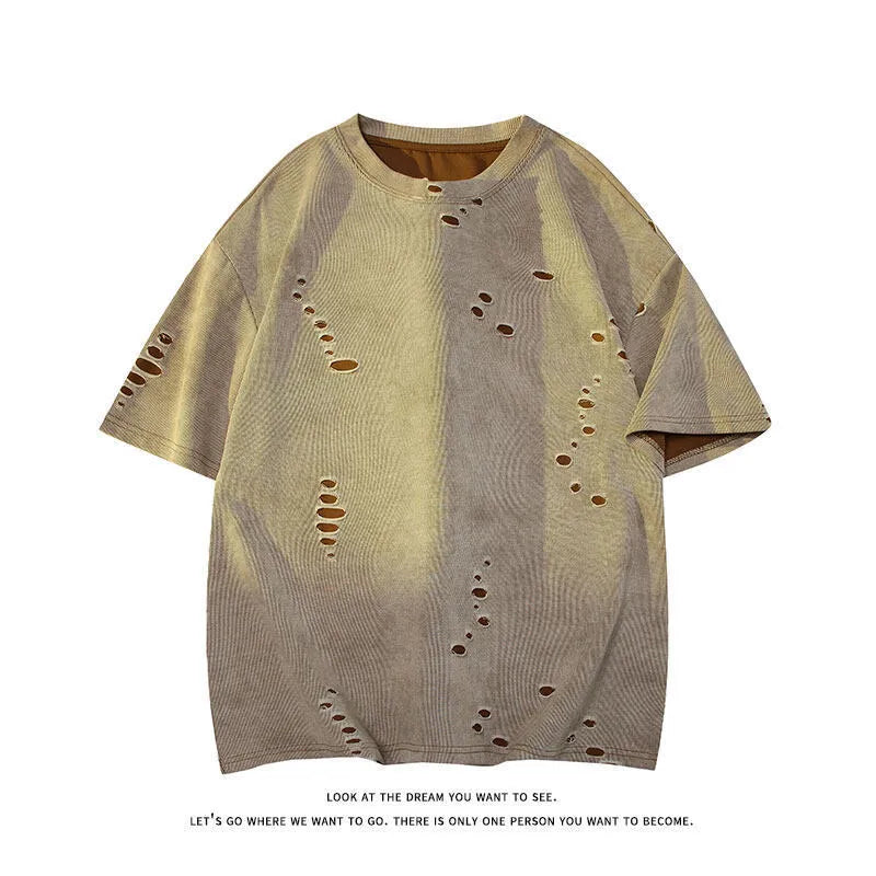 Men's blue loose-fit distressed short-sleeve t-shirt with ripped fabric detailing on a casual backdrop.