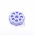 Silicone pet grooming brush with ergonomic handle shown in blue, for washing and brushing dogs and cats.