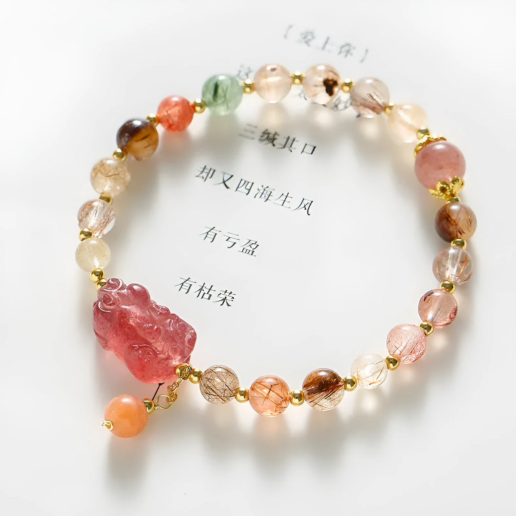 Women's strawberry quartz crystal bracelet with copper construction and pearl detailing in Chinese style design.
