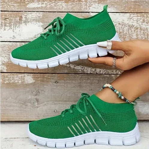 Women's breathable lace-up sneaker in a low-top style with a flat rubber sole.