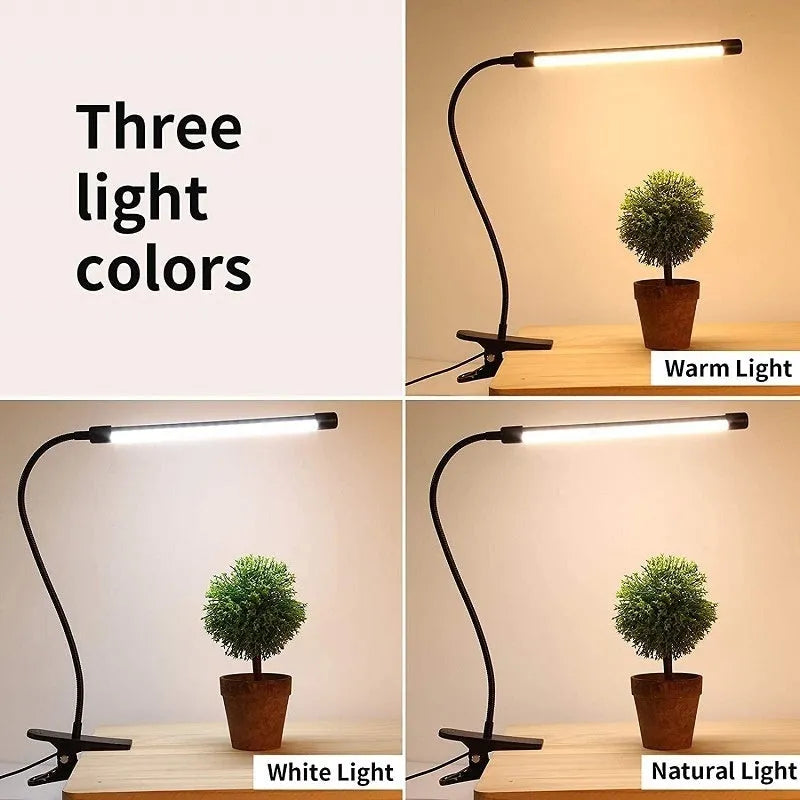 Black and white USB-powered LED desk lamp with a 26 cm long adjustable gooseneck neck on a table.