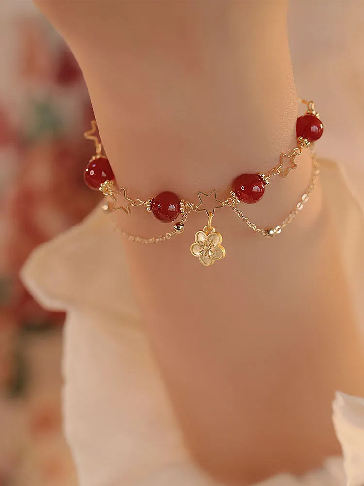 Red agate double layer women's bracelet with floral peach blossom charms on adjustable fastening