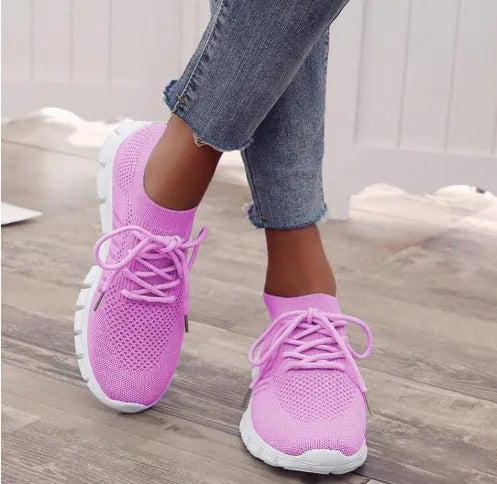 Women's breathable lace-up sneaker in a low-top style with a flat rubber sole.