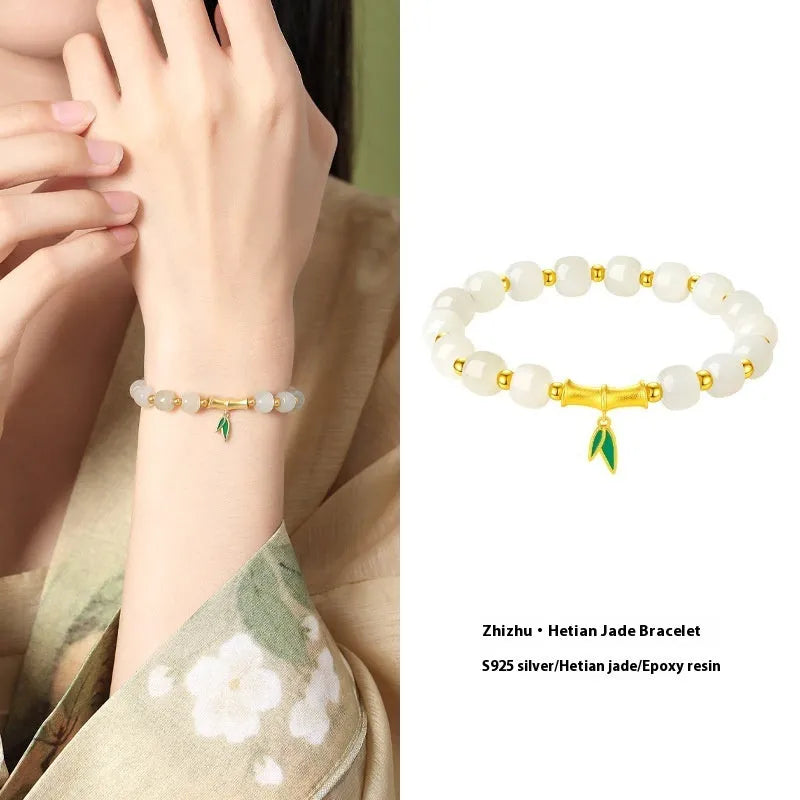 Natural Hetian jade and sterling silver bamboo leaf bracelet on a wrist, showing gold and silver finish options.