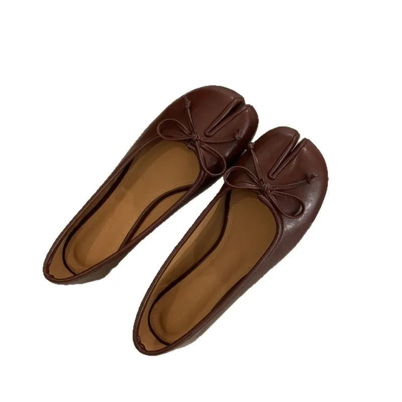 Women's split-toe flat pump shoes in beige with a round toe and shallow cut.
