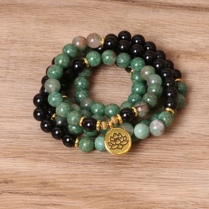 Green and black alloy elastic beaded bracelet with natural styling on wrist
