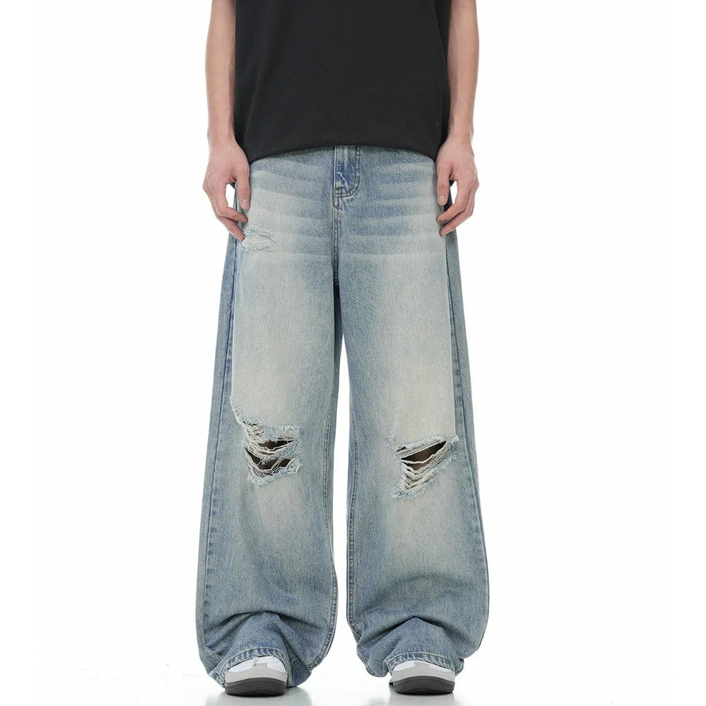 Man wearing blue retro-style distressed straight-leg cotton blend jeans.
