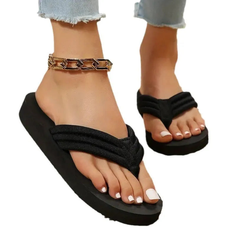 Black women's flat slippers with a cotton cloth upper and a solid sole, shown in a casual style.