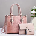 Three-piece crossbody bag set in contrasting colour showing bucket-style main bag with wallet and card holder