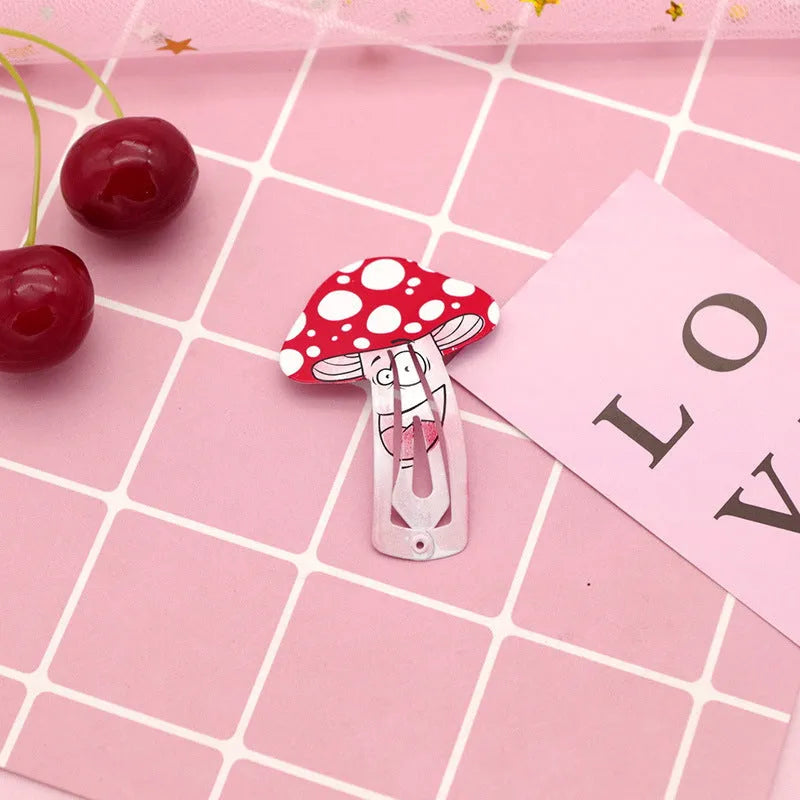 Colourful metal hair barrette for children with a printed strawberry design.