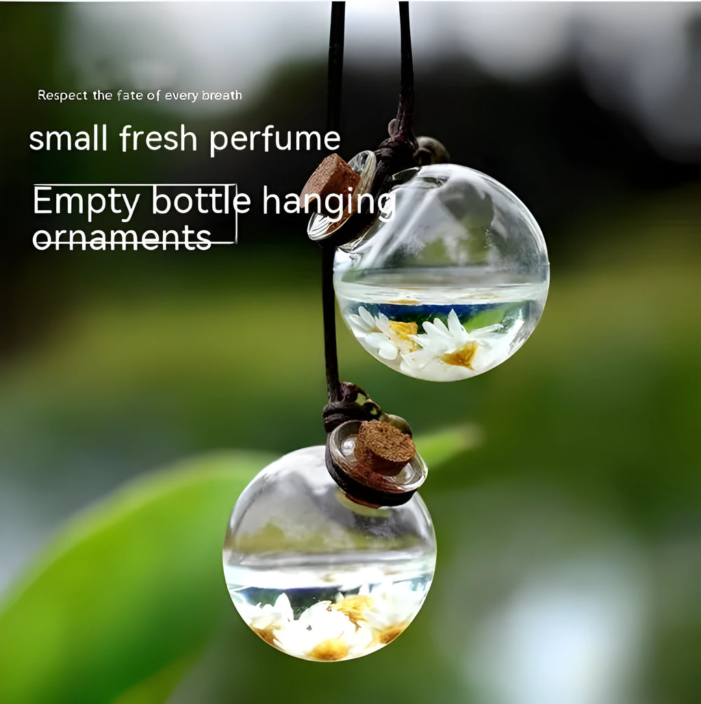 Glass car perfume pendant with preserved flowers inside, shown in light pink hydrangea colour