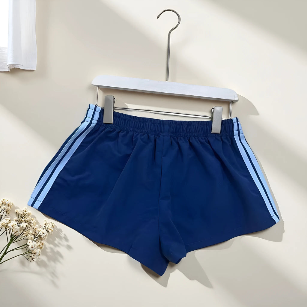 Men's navy blue high-waist nylon sports shorts laid flat, showing casual style and micro-elastic fabric.
