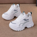 Women's white and beige height-increasing dad shoes with cross straps and lace-up front.