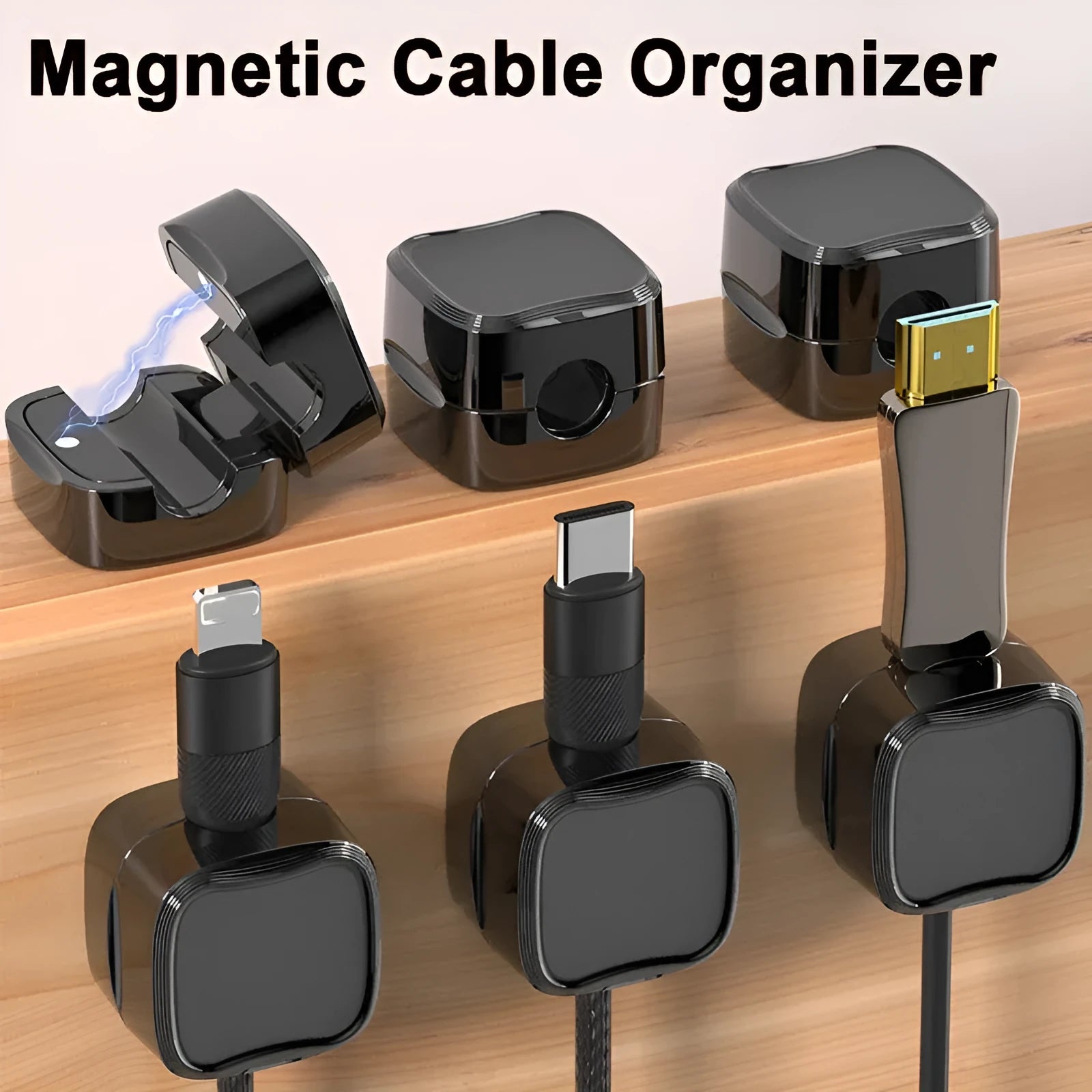 White and black magnetic adhesive cable clips holding a USB cable against a wooden desk.