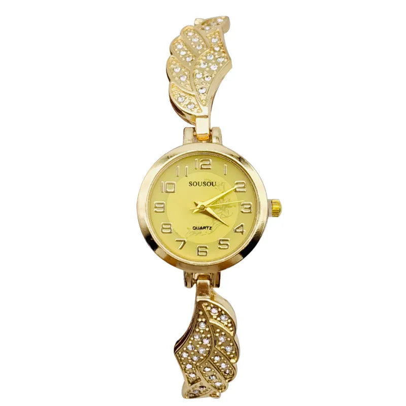 Stainless steel women's watch with round dial on wrist, showing gold colour surface and vachette clasp.