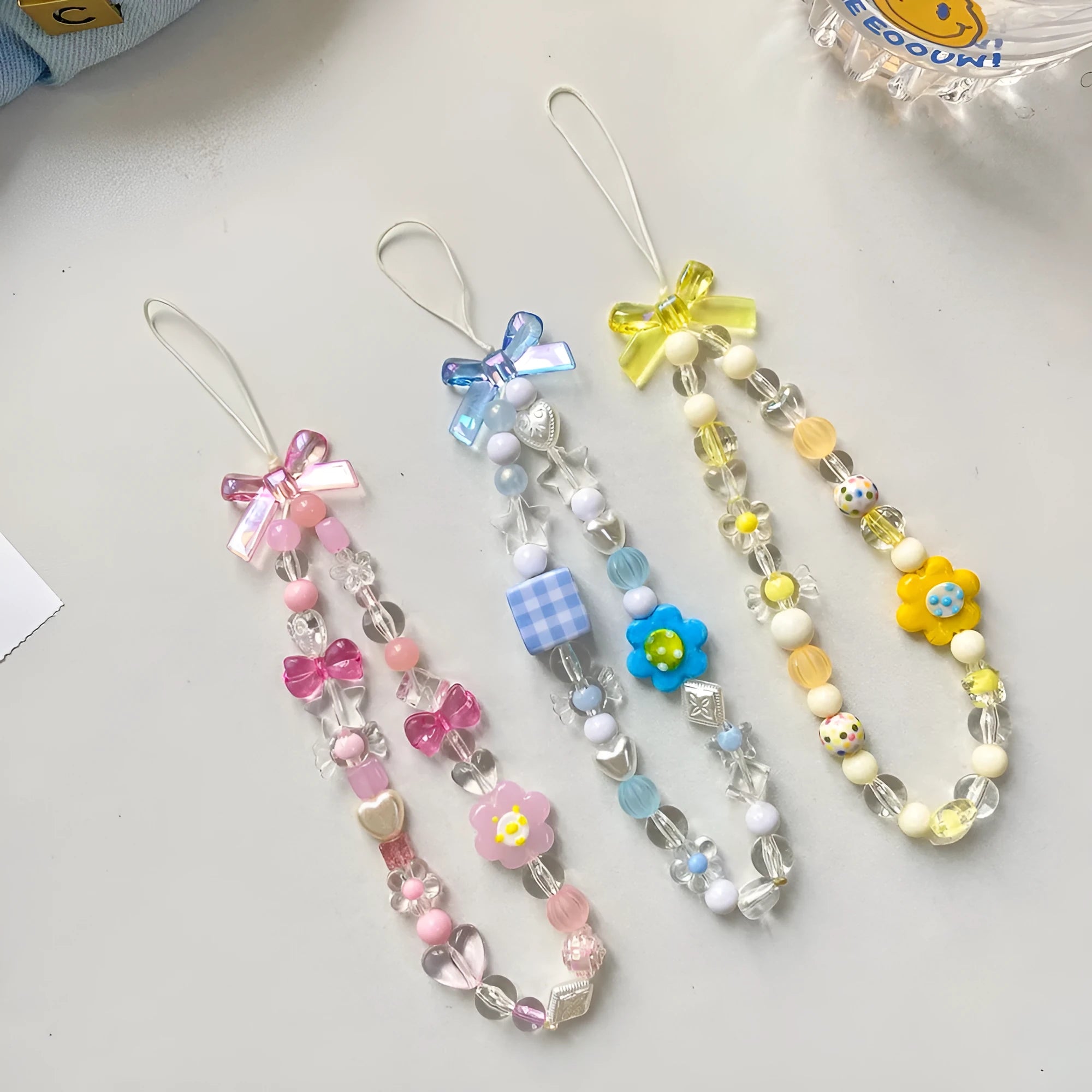 Beaded flower mobile phone lanyard with hand rope design in yellow, blue, or pink colour options